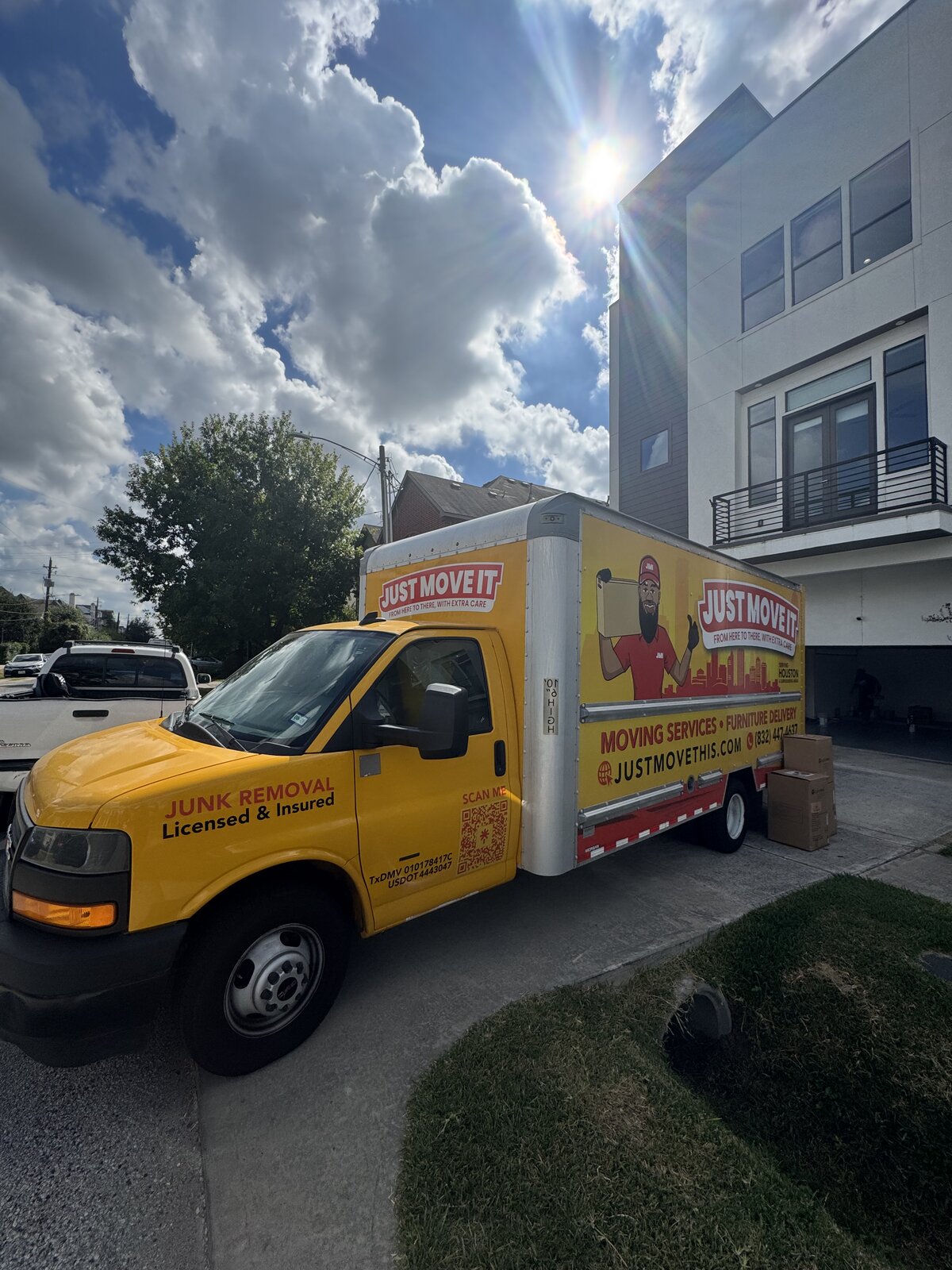 Just Move It branded box truck on a Houston driveway